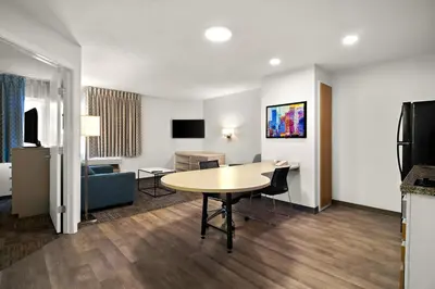 a hotel room with a table and a living room at MainStay Suites Orlando Altamonte Springs in Orlando