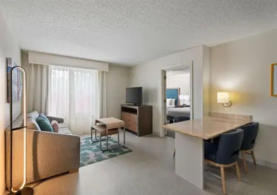a living room with a couch and a table in a room at Homewood Suites by Hilton Lake Mary Orlando North in Lake Mary