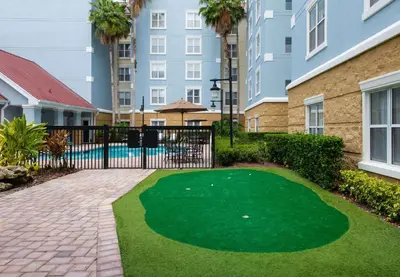 a golf course in the courtyard of a apartment building at Homewood Suites by Hilton Lake Mary Orlando North in Lake Mary
