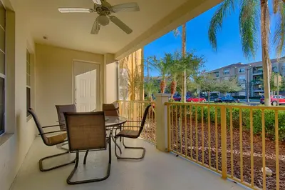 a patio with a table and chairs on a balcony at Hidden Treasure in Orlando