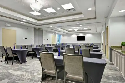 a conference room with a long table and chairs at Hilton Garden Inn Orlando Lake Buena Vista in Orlando