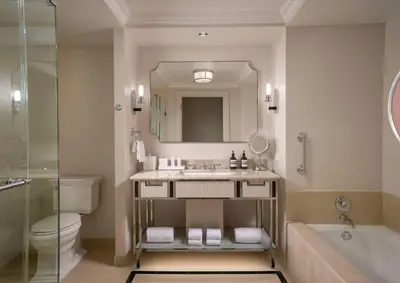 a bathroom with a sink and a tub and a toilet at Waldorf Astoria Orlando - An Official Walt Disney World Hotel in Orlando