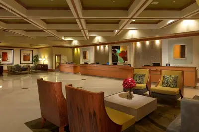 a lobby with a waiting area with chairs and a table at Hilton Grand Vacations Club Parc Soleil Orlando in Orlando