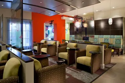 a waiting room with brown chairs and a bar at Hilton Grand Vacations Club Parc Soleil Orlando in Orlando