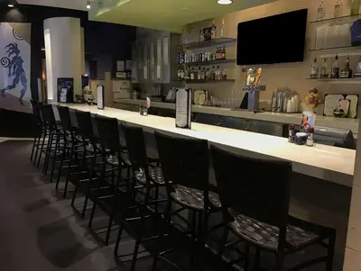 a row of chairs sitting at a bar in a restaurant at Hilton Grand Vacations Club Parc Soleil Orlando in Orlando