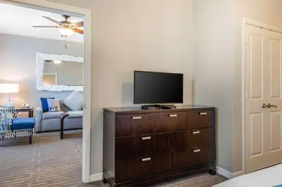 a living room with a flat screen tv on a dresser at Bluegreen Vacations Fountains, an Ascend Collection Resort in Orlando