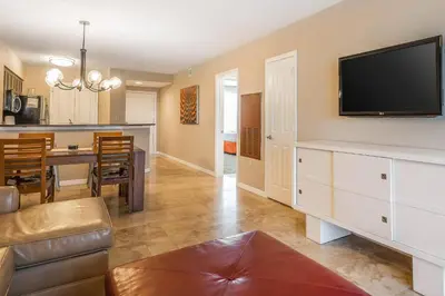 a living room and dining room with a flat screen tv at Bluegreen Vacations Fountains, an Ascend Collection Resort in Orlando