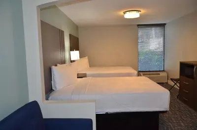 a hotel room with two beds and a window at Opal Hotel & Suites in Orlando