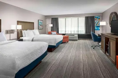 a hotel room with two beds and a television at Hampton Inn & Suites at Lake Mary Colonial Townpark in Lake Mary