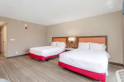 two beds in a hotel room with white and red at Hampton Inn & Suites Orlando-Apopka in Orlando