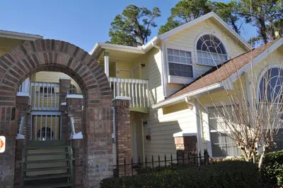 a house with an archway in front of it at Villas at Laguna Bay in Kissimmee