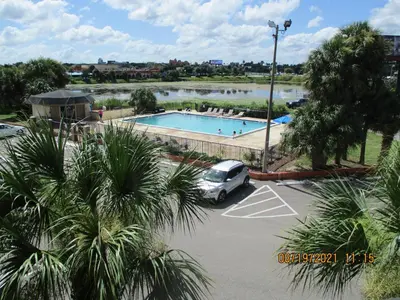 a car parked in a parking lot next to a swimming pool at Quality Inn & Suites Kissimmee near Main Gate in Orlando