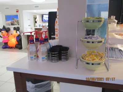 a counter in a store with drinks and food at Quality Inn & Suites Kissimmee near Main Gate in Orlando