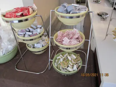 a shelf filled with plates of food on a counter at Quality Inn & Suites Kissimmee near Main Gate in Orlando