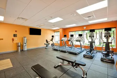 a gym with treadmills and elliptical machines at Homewood Suites by Hilton Orlando Theme Parks in Orlando