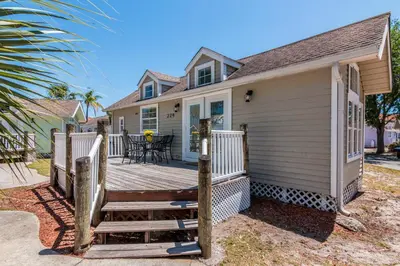 a home with a wooden deck with a table on it at Tropical Palms Resort in Orlando