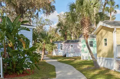 a walkway in front of houses with palm trees at Tropical Palms Resort in Orlando