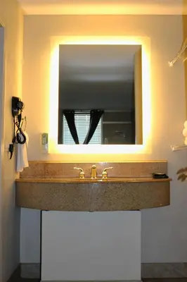 a bathroom sink with a large mirror above it at Magic Key - Near Disney in Kissimmee
