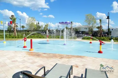 a pool with a water park with a fountain at Four Bedrooms Home with Pool 3079 in Kissimmee