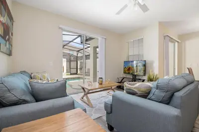 a living room with two couches and a table at Four Bedrooms Home with Pool 3079 in Kissimmee