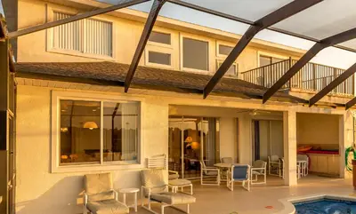 a house with a patio and a swimming pool at Suaimhneas in Kissimmee