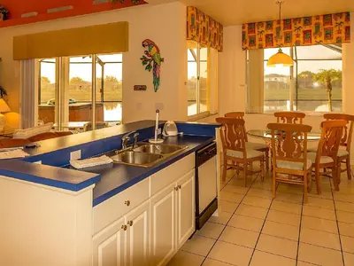 a kitchen with a sink and a table with chairs at Suaimhneas in Kissimmee