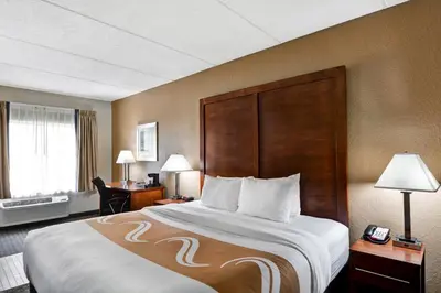 a hotel room with a bed and a desk at Quality Inn & Suites Heritage Park in Kissimmee