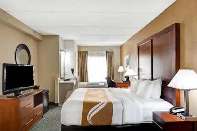 a hotel room with a large bed and a television at Quality Inn & Suites Heritage Park in Kissimmee