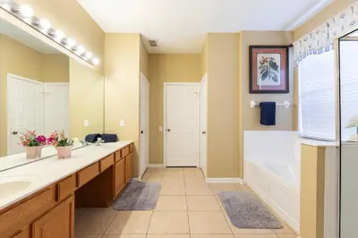 a bathroom with two sinks and a tub and a shower at Windsor Hills Resort 2 Miles to Disney 6-Bedroom 4-Bathrooms Villa with Private Pool and Spa in Orlando