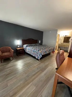 a bedroom with a bed and a table and chairs at Riviera Motel in Kissimmee