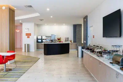 a room with a kitchen with a counter and a table at TownePlace Suites by Marriott Orlando at SeaWorld in Orlando