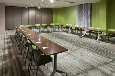 a conference room with long tables and chairs at TownePlace Suites by Marriott Orlando at SeaWorld in Orlando