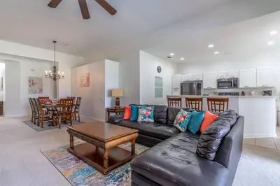 a living room with a leather couch and a table at 7741 Windsor Hills in Orlando