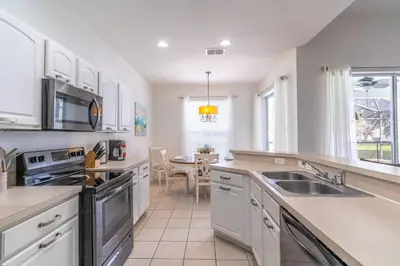 a kitchen with a sink and a stove top oven at 7741 Windsor Hills in Orlando