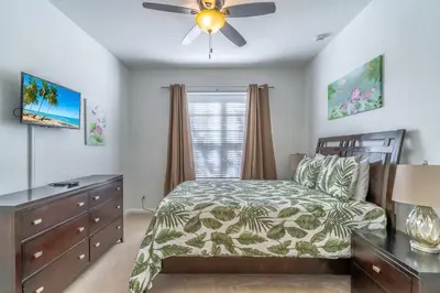 a bedroom with a bed and a ceiling fan at 7741 Windsor Hills in Orlando