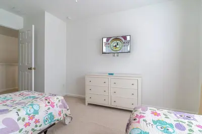 a bedroom with a bed and a clock on the wall at 7741 Windsor Hills in Orlando