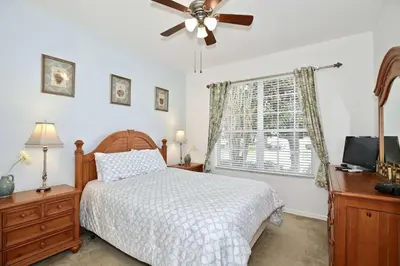 a bedroom with a bed and a ceiling fan at 2627 Windsor Hills in Orlando
