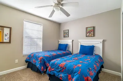 a bedroom with two beds and a ceiling fan at 8965 Paradise in Kissimmee