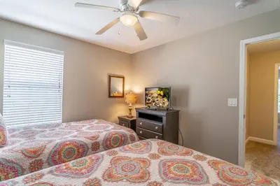 a bedroom with two beds and a flat screen tv at 8965 Paradise in Kissimmee
