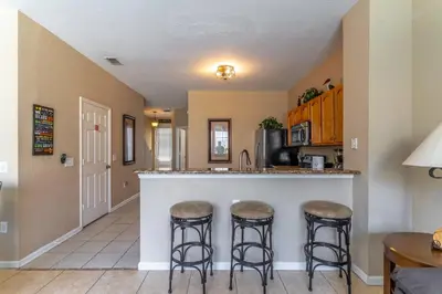 a kitchen with two bar stools at a counter at 7669 Windsor Hills in Orlando