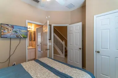 a bedroom with a bed and a flat screen tv at 7669 Windsor Hills in Orlando