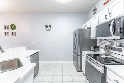 a kitchen with white counters and stainless steel appliances at 3031 Encantada in Kissimmee