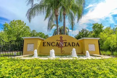 a sign for encantada in front of a fountain at 3031 Encantada in Kissimmee