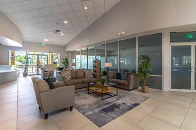 an office lobby with couches and tables and windows at 3031 Encantada in Kissimmee