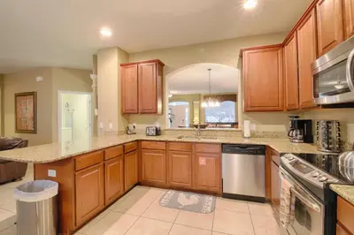 a kitchen with wooden cabinets and a counter top at 2540 Windsor Hills in Orlando