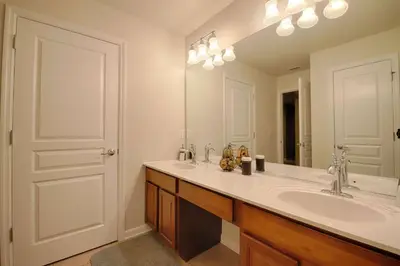 a bathroom with a sink and a large mirror at 2540 Windsor Hills in Orlando