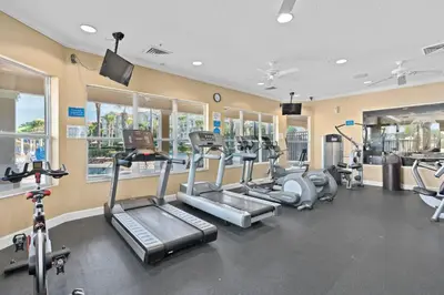 a gym with several treadmills and machines in a room at 2540 Windsor Hills in Orlando
