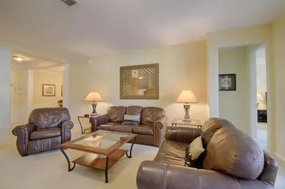 a living room with leather couches and a coffee table at 5036 105 Viz Cay in Orlando