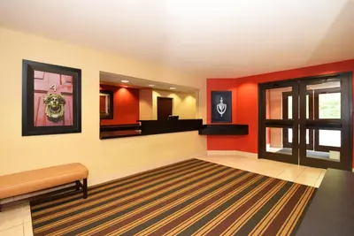a waiting room with red walls and a mirror at Extended Stay America Select Suites - Orlando - Conven Ctr - Sports Complex in Orlando