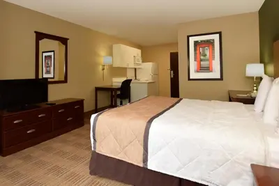 a hotel room with a bed and a television at Extended Stay America Select Suites - Orlando - Conven Ctr - Sports Complex in Orlando